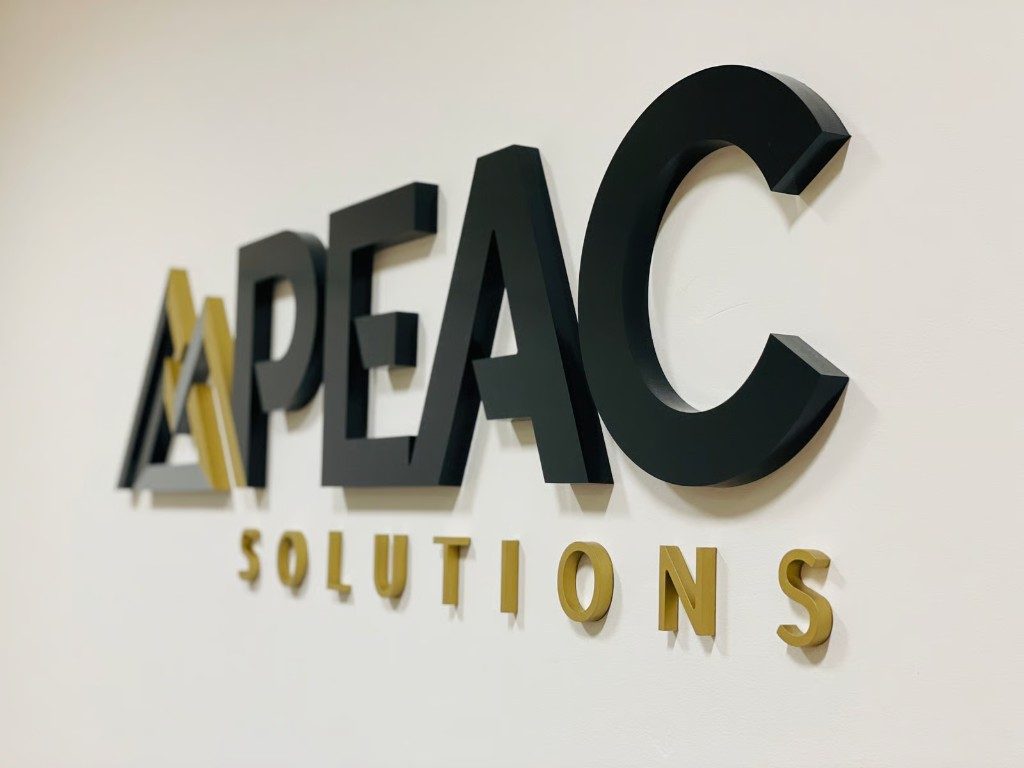 APEAC Solutions black and gold 3D built-up lettering