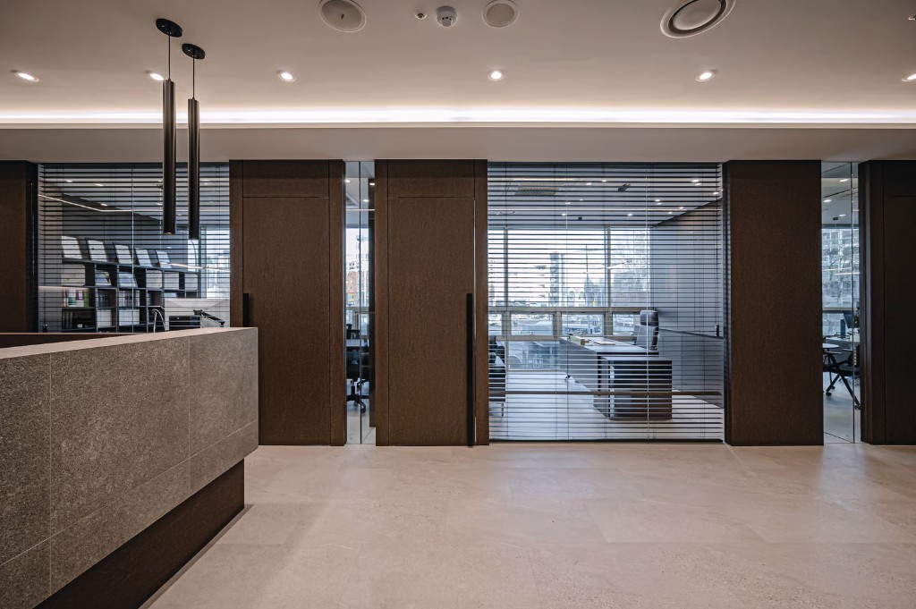 Dark wood wrap panels and doors in an office reception