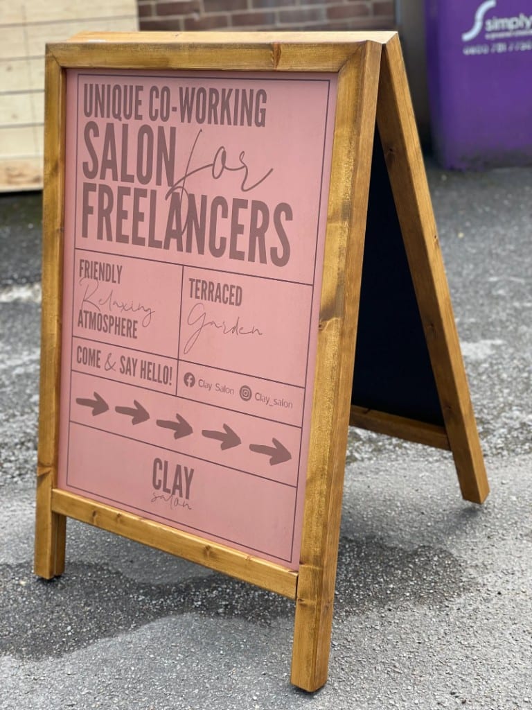 Clay salon wooden A-board pavement sign with directional arrows