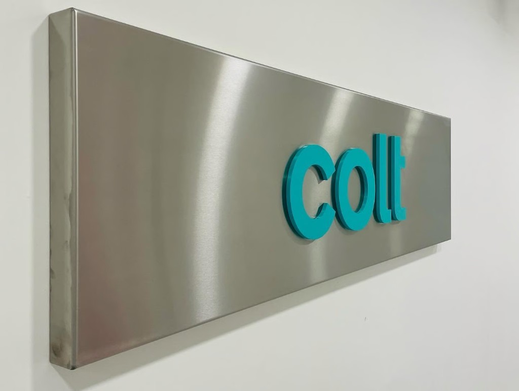 Coll teal acrylic lettering on a brushed metal plaque