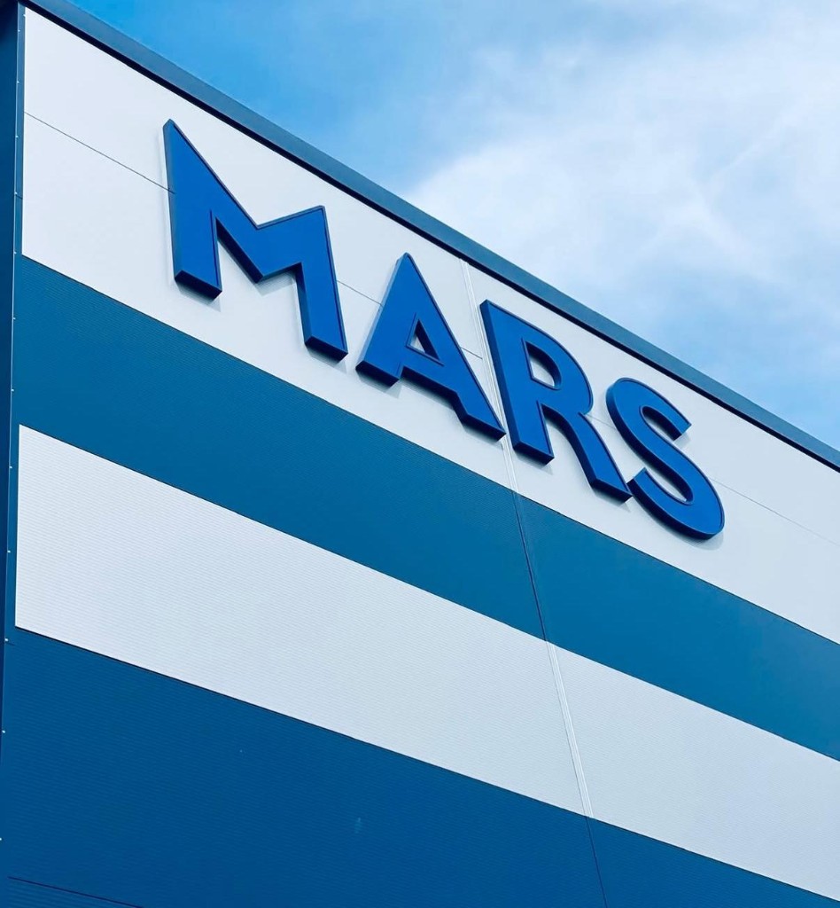Large blue built-up exterior lettering on a commercial building facade