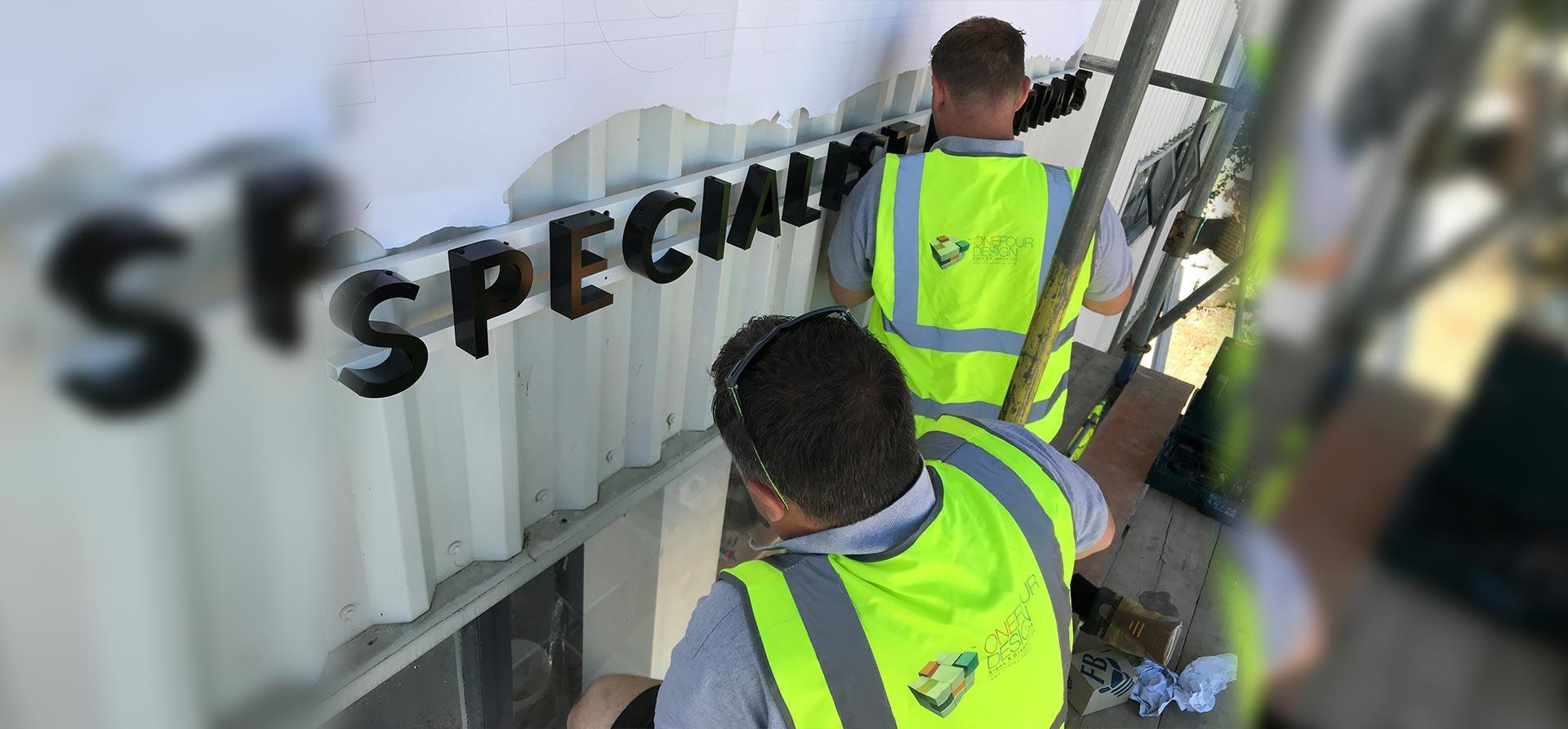 One Four Design team installing signage