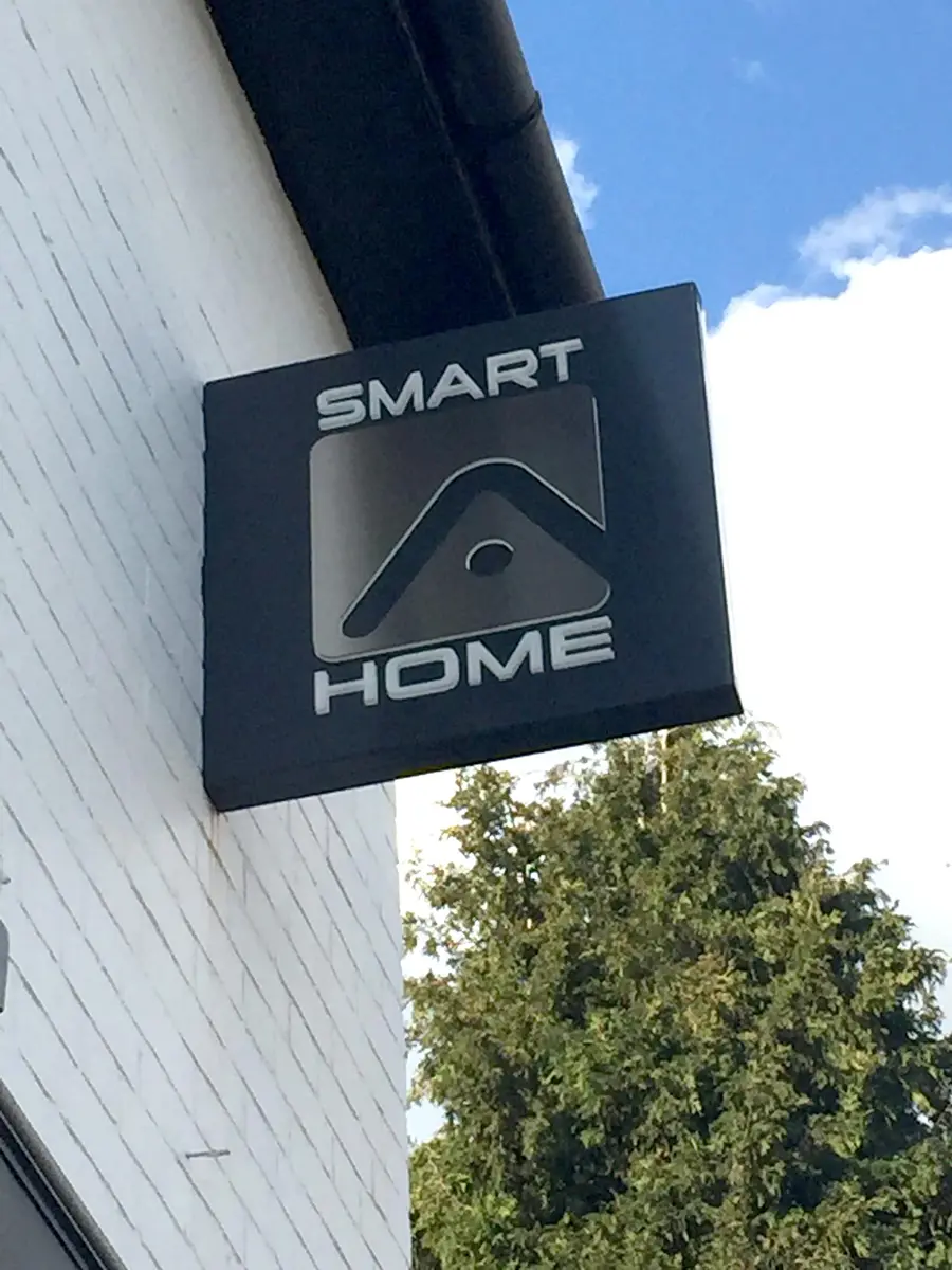 Round projecting sign fitted to a shopfront