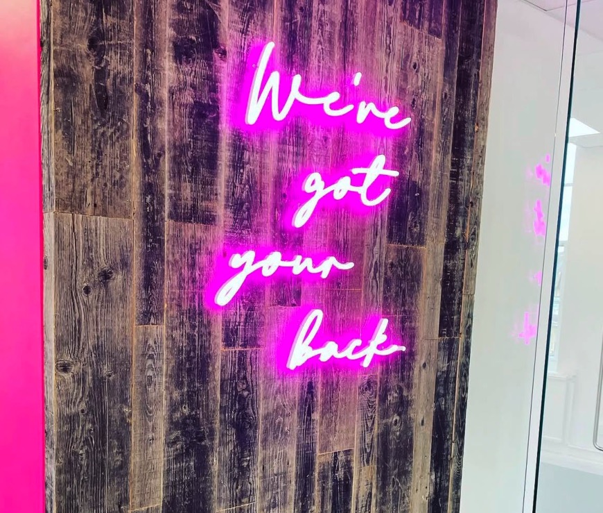 Custom pink neon sign installed for a retail brand