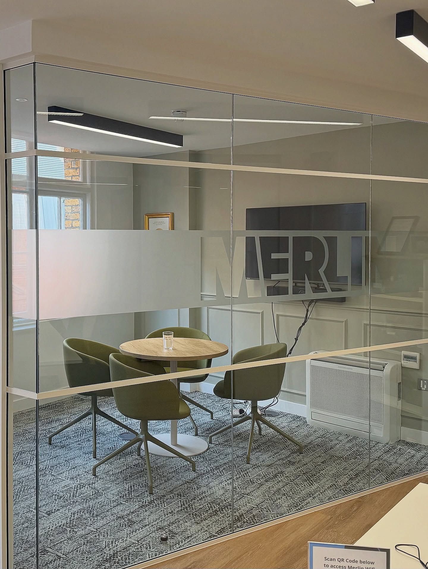 Branded privacy film detail on office glass